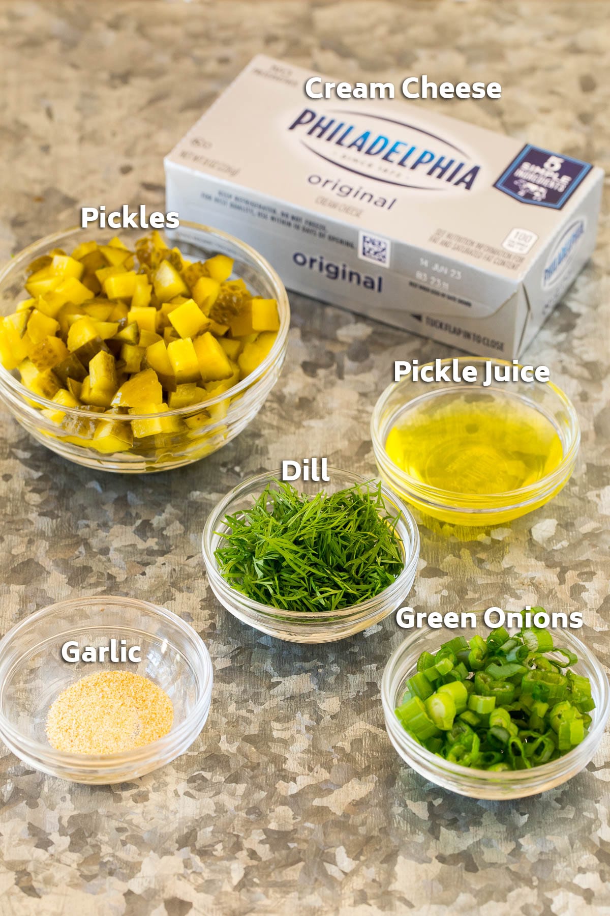 Ingredients including cream cheese, pickles, herbs and spices.