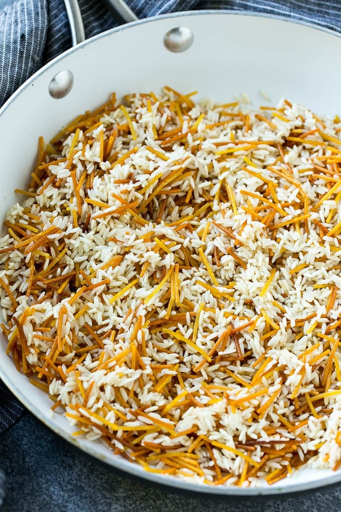 Toasted pasta and rice in a skillet.