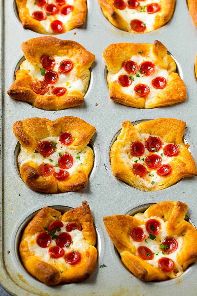 Savory pizza muffins in a muffin tin.