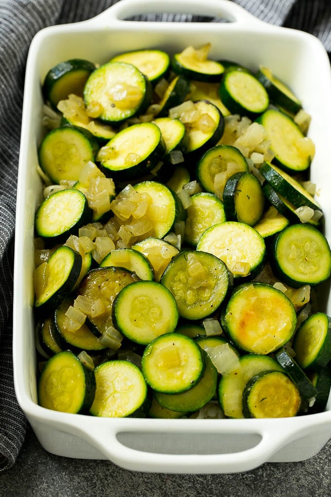 Sauteed zucchini and onions in a baking dish.