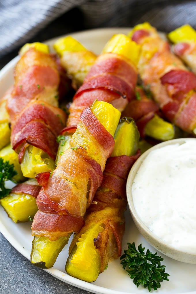 Bacon wrapped pickle fries garnished with parsley.