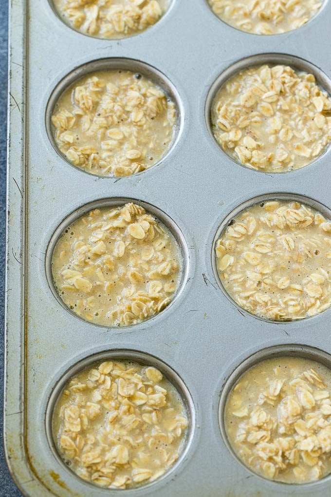 Baked oatmeal cup batter poured into muffin tins.