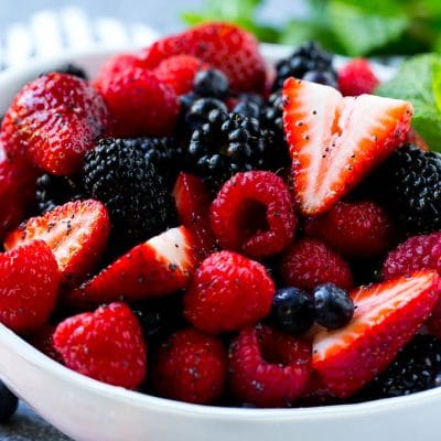 A berry salad with raspberries, blueberries, blackberries and strawberries all in a honey based dressing.