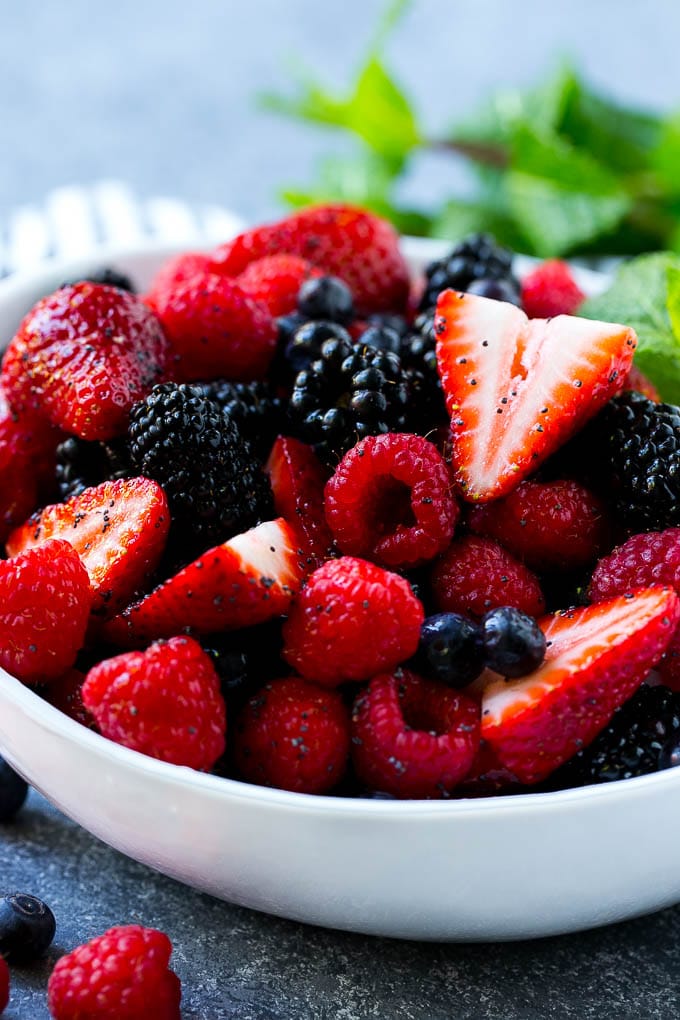 A berry fruit salad with raspberries, blueberries, blackberries and strawberries all in a honey based dressing.