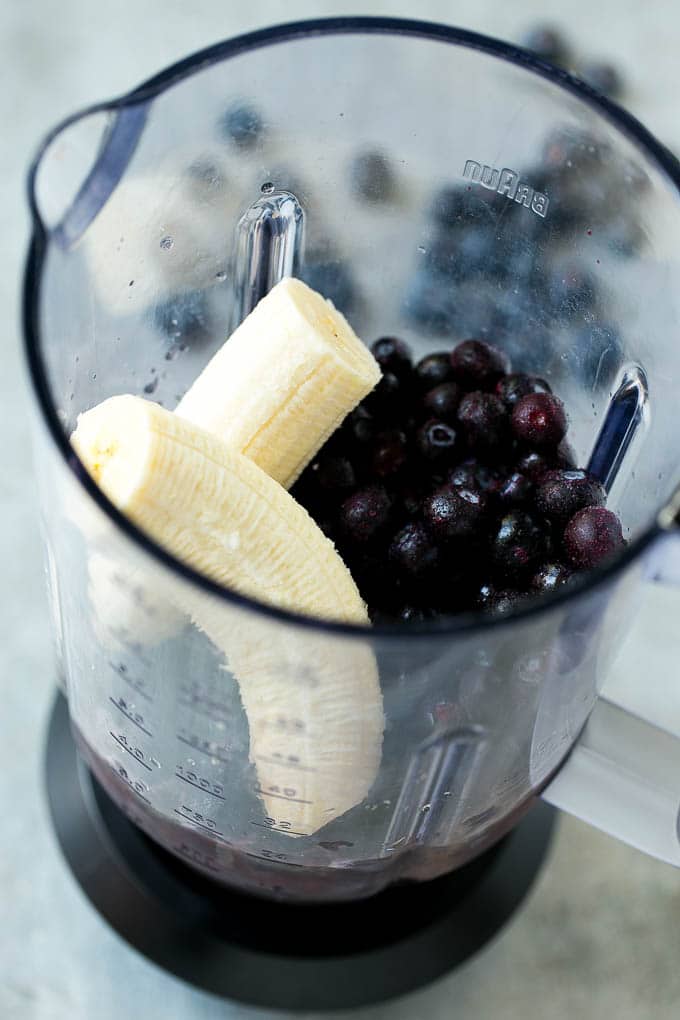 Blueberries, banana, juice and yogurt in a blender.