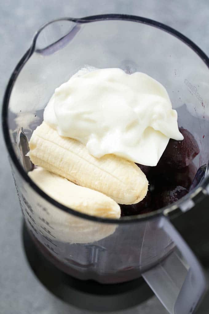 Cherries, banana, yogurt and juice in a blender.