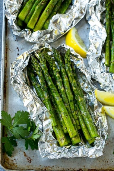 Grilled asparagus in foil topped with parsley and seasonings.