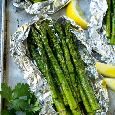 Grilled asparagus in foil topped with parsley and seasonings.