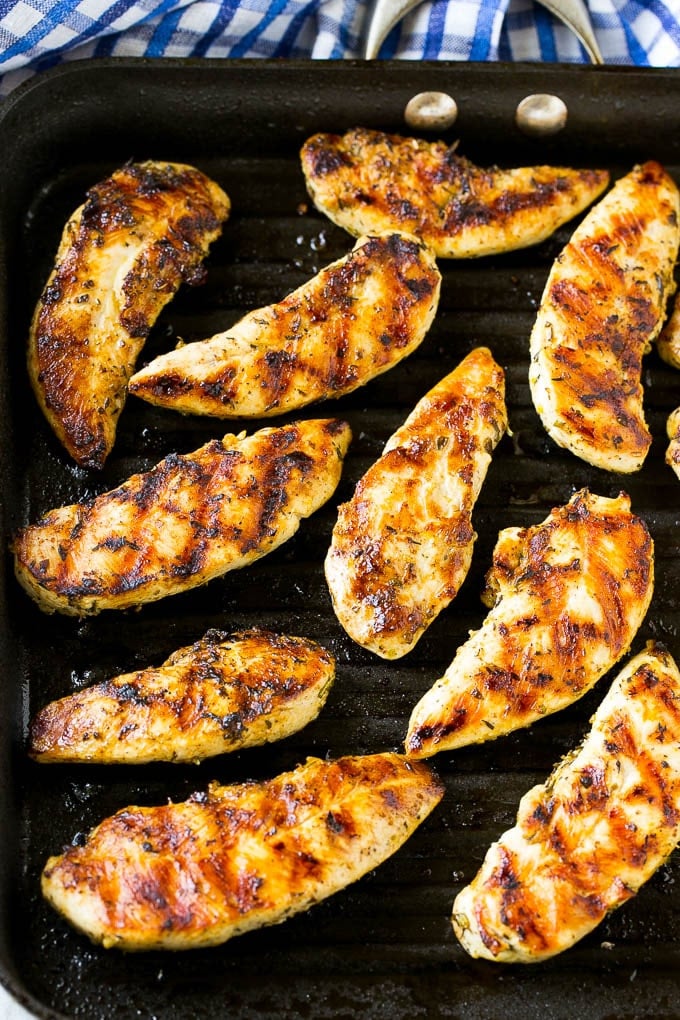 Chicken tenders cooking on a grill pan.