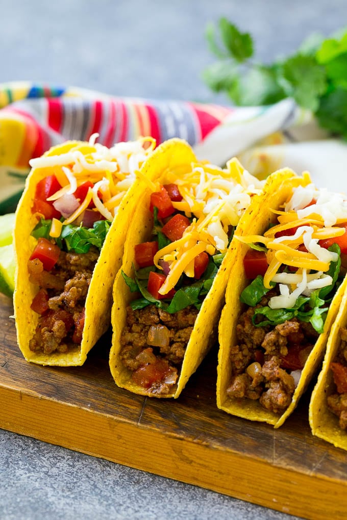 Taco shells filled with seasoned ground beef, lettuce, tomatoes, onions and cheese.
