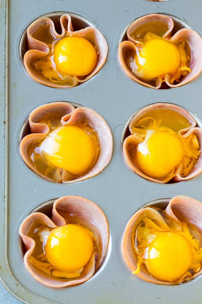 Ham pressed into muffin tins and topped with eggs and cheese.