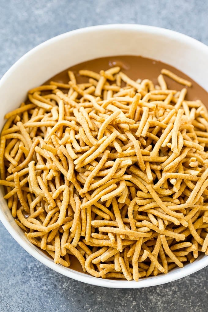 A bowl of melted chocolate and chow mein noodles.