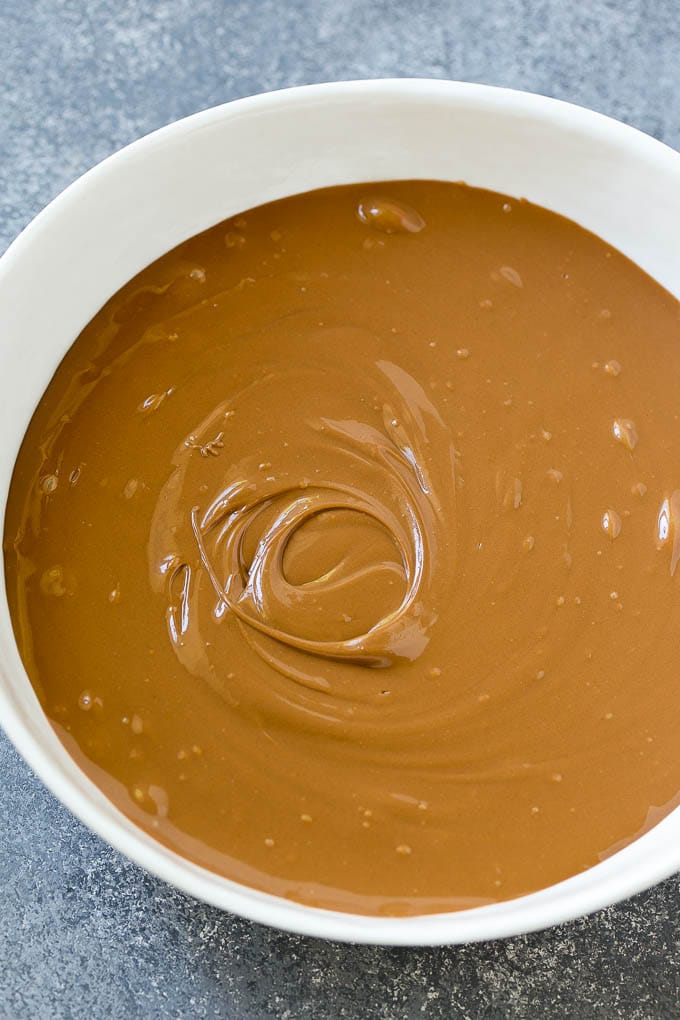 A bowl of melted milk chocolate chips and butterscotch chips.