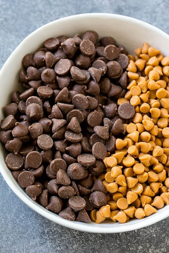 A mixing bowl of milk chocolate and butterscotch chips.