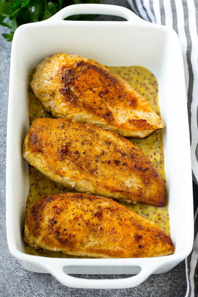 Seared chicken breasts in a baking dish.