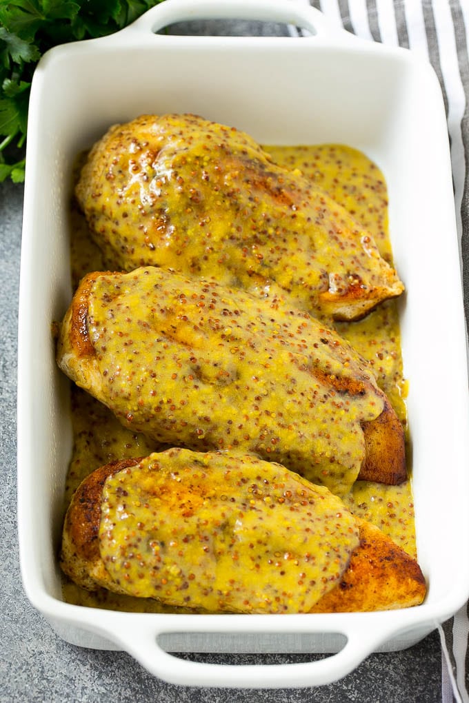 Chicken breasts in a baking dish topped with sauce.