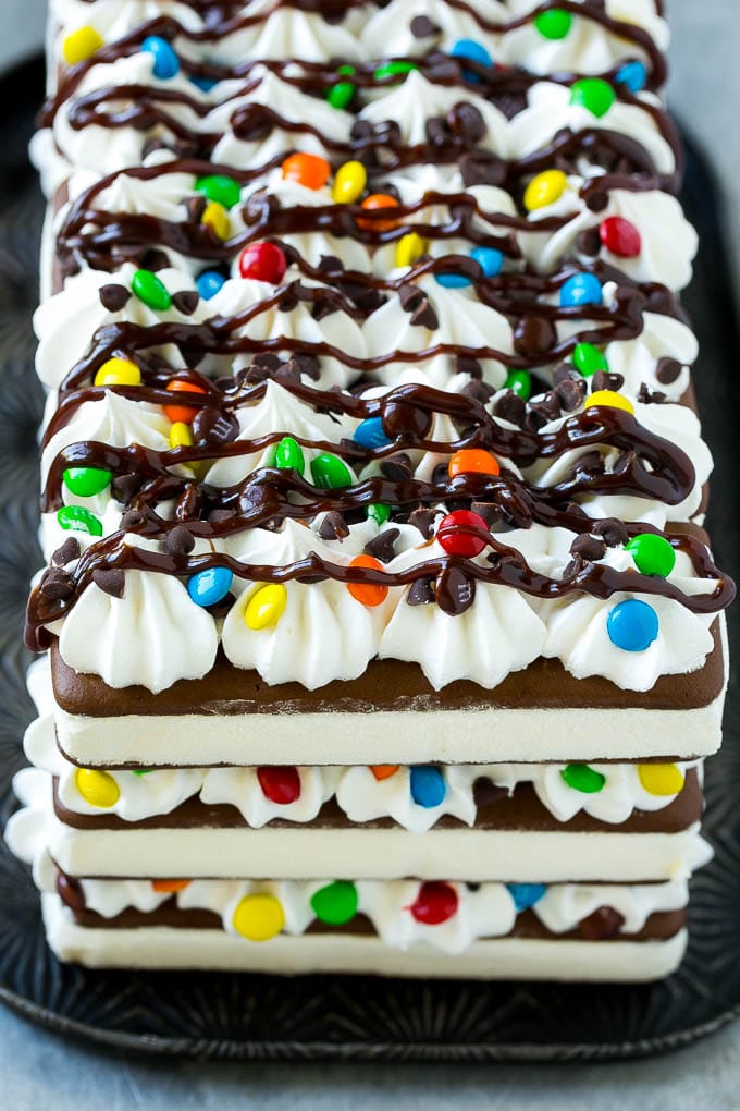 The front view of an ice cream sandwich cake drizzled with fudge.