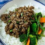 A bowl of rice topped with Korean ground beef and mixed vegetables.