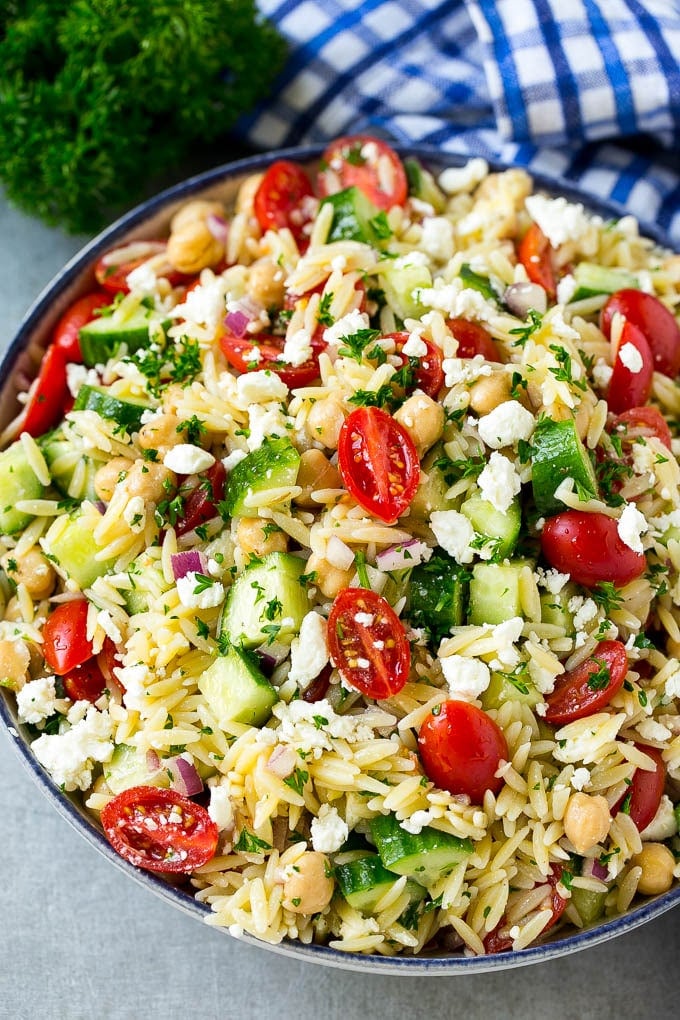 Greek orzo salad with pasta, cucumbers, tomatoes and feta cheese.