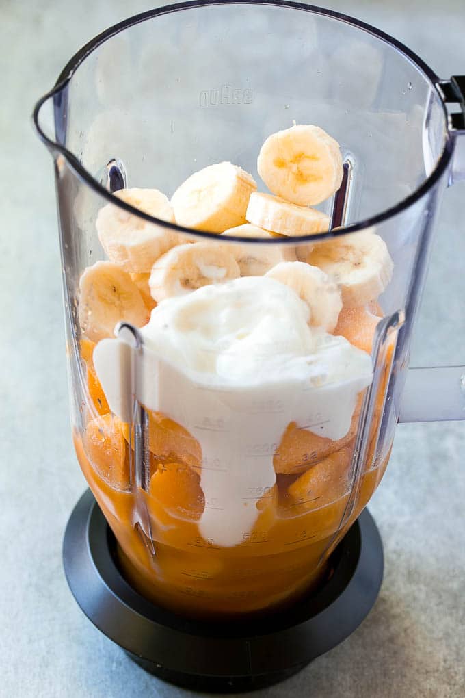 Peach nectar, frozen peaches, mango, banana and yogurt in a blender.