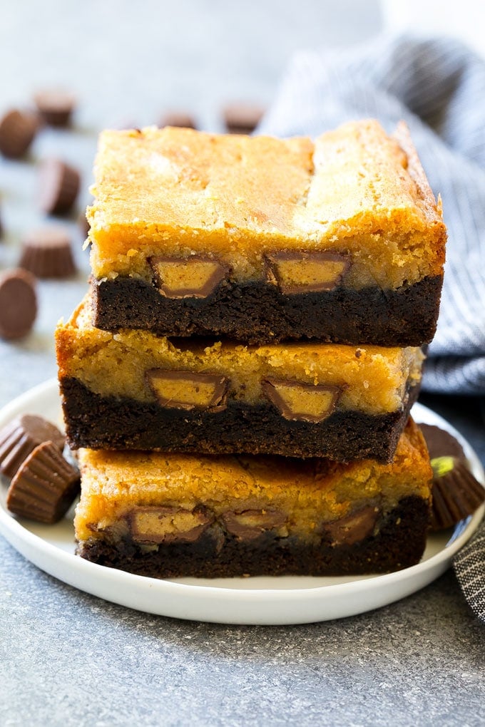 A stack of peanut butter chocolate gooey butter cake slices.