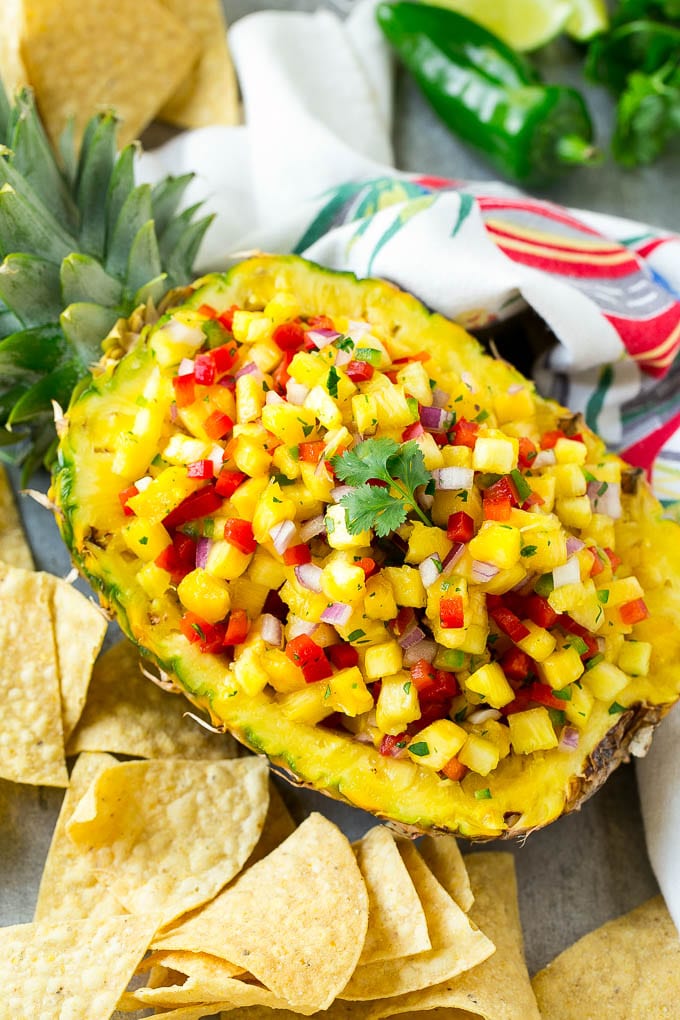 Pineapple salsa served inside a pineapple with tortilla chips.