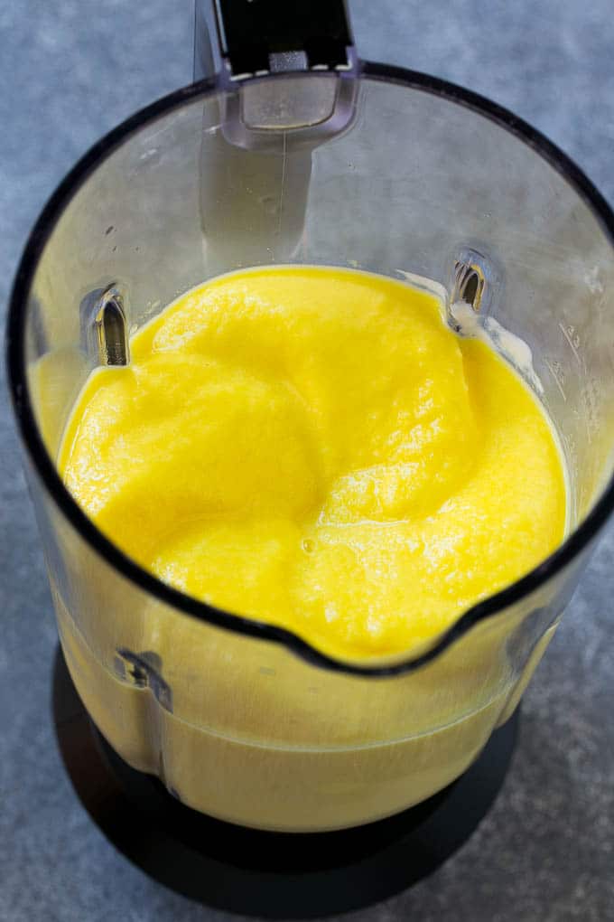 A blender full of pineapple smoothie.