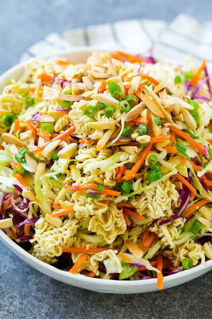 Ramen noodle salad full of shredded cabbage, sliced almonds, carrots and green onions.