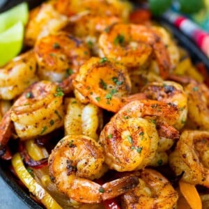 These shrimp fajitas are tender Mexican seasoned shrimp cooked in a skillet with plenty of peppers and onions.