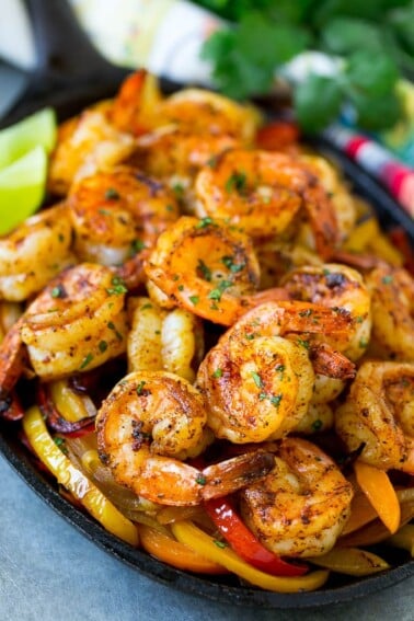 These shrimp fajitas are tender Mexican seasoned shrimp cooked in a skillet with plenty of peppers and onions.