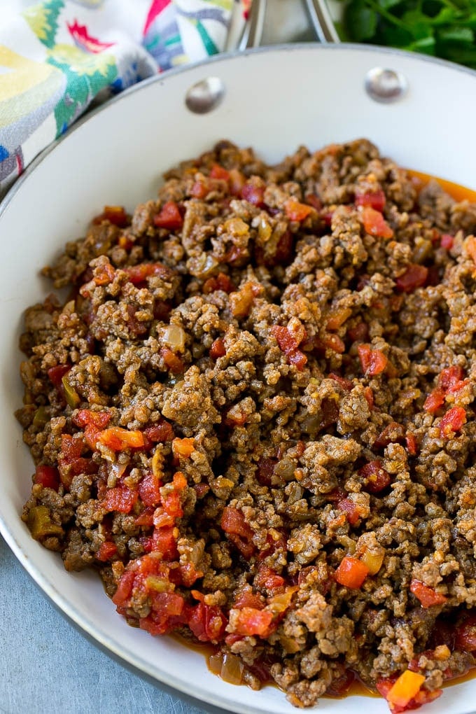 A skillet of cooked ground beef and tomatoes.