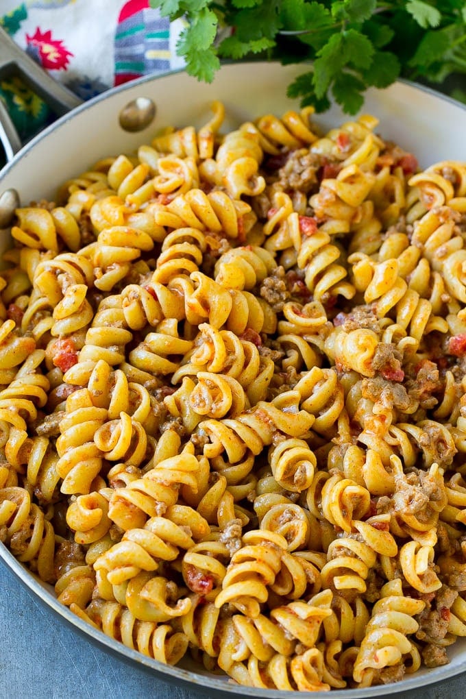 Rotini pasta mixed with ground beef and tomatoes in a creamy sauce.