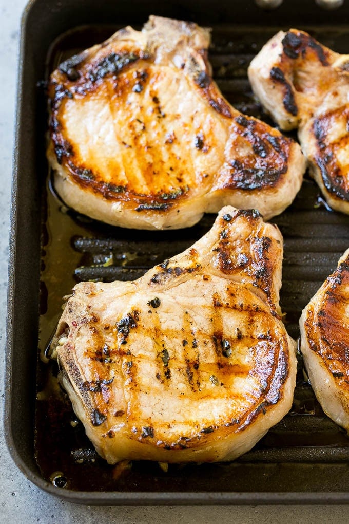 Grilled pork chops on a grill pan.