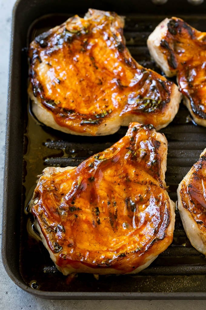 Grilled pork chops brushed with BBQ sauce.