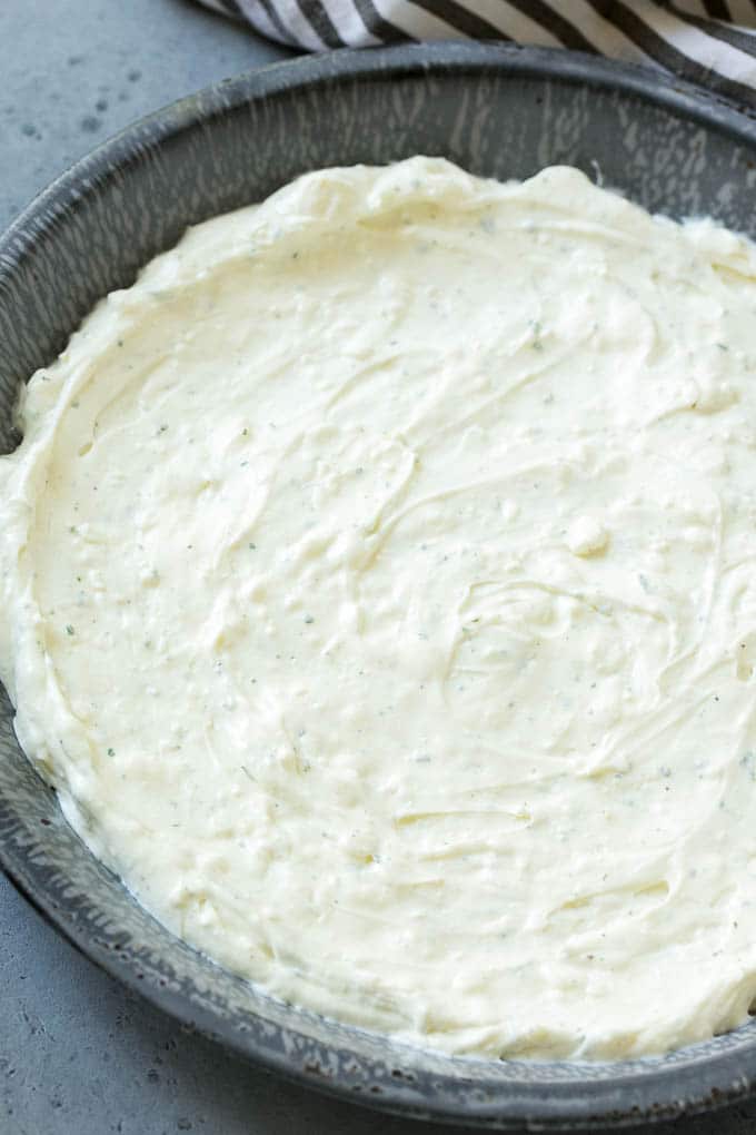 A layer of cream cheese and sour cream mixed with ranch seasoning.