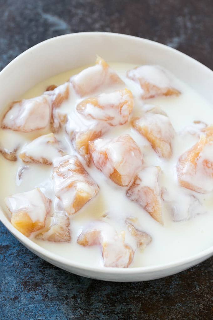 Chicken breast pieces soaking in buttermilk.