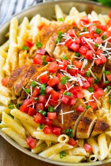Cajun chicken pasta with grilled chicken breast, creamy penne pasta, tomatoes and green onions.