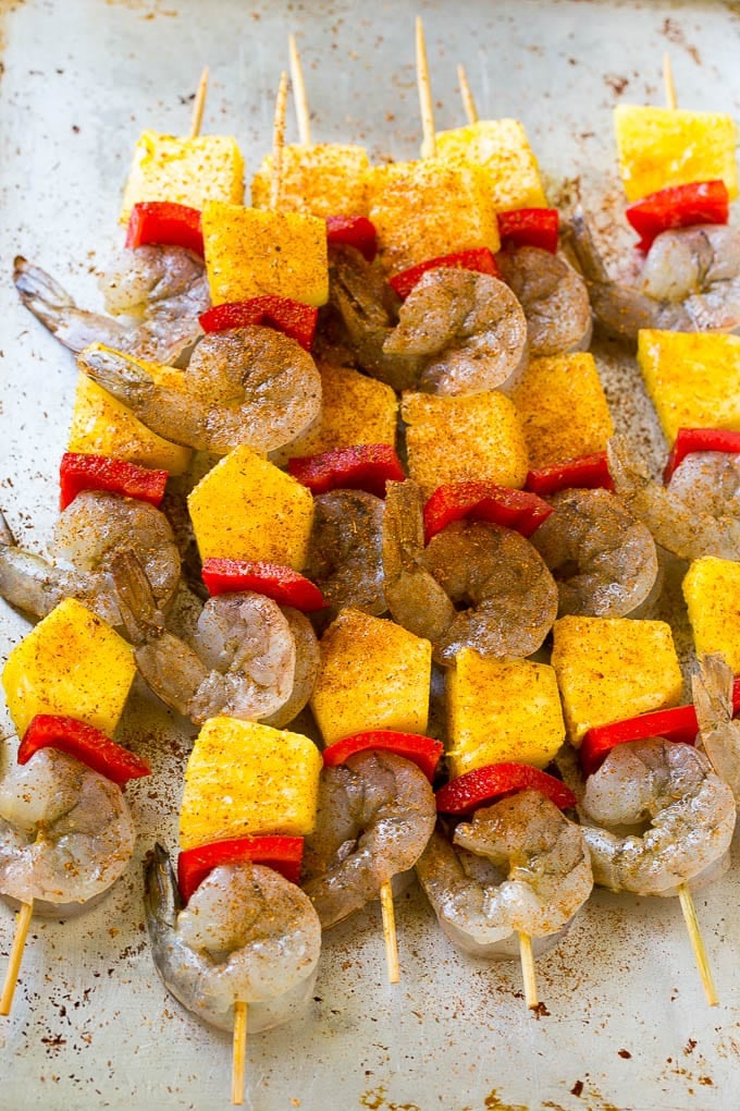 Shrimp, pineapple and peppers on wood skewers, topped with jerk seasoning.