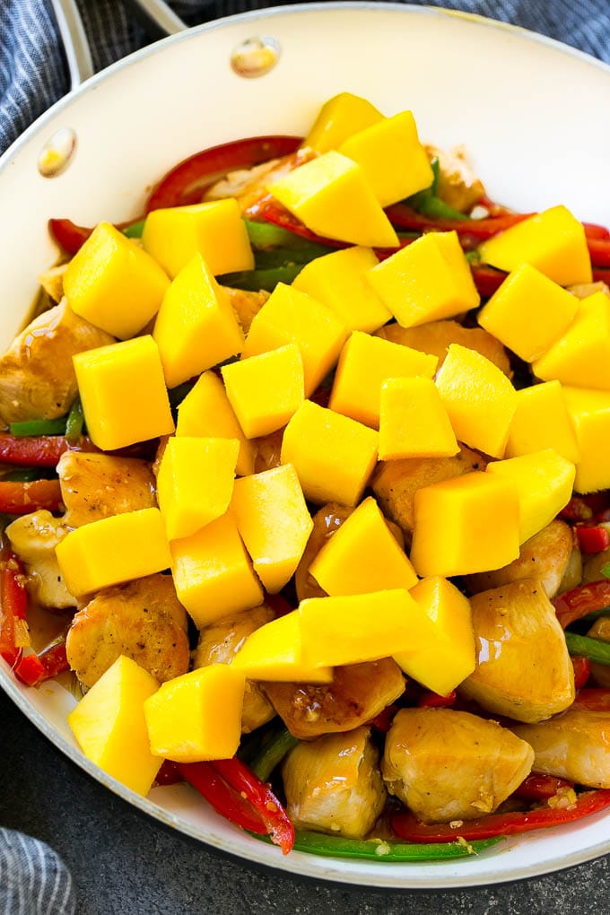 Chicken stir fry with mango chunks.