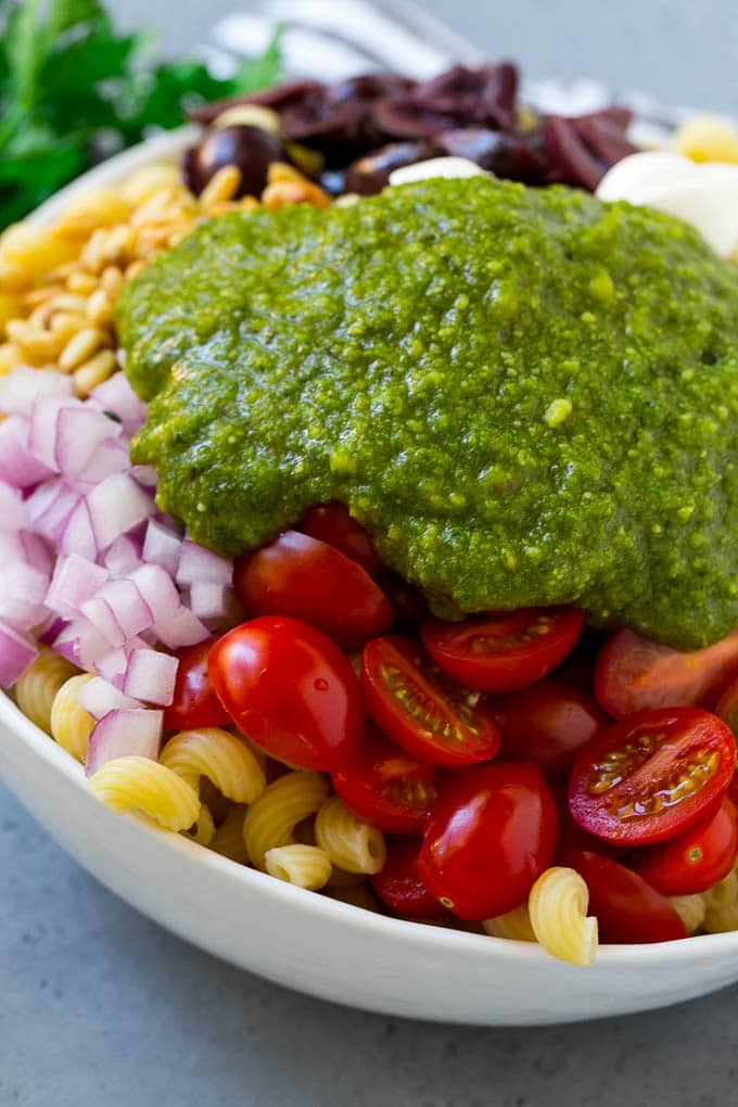 Vegetables and corkscrew pasta topped with fresh pesto.