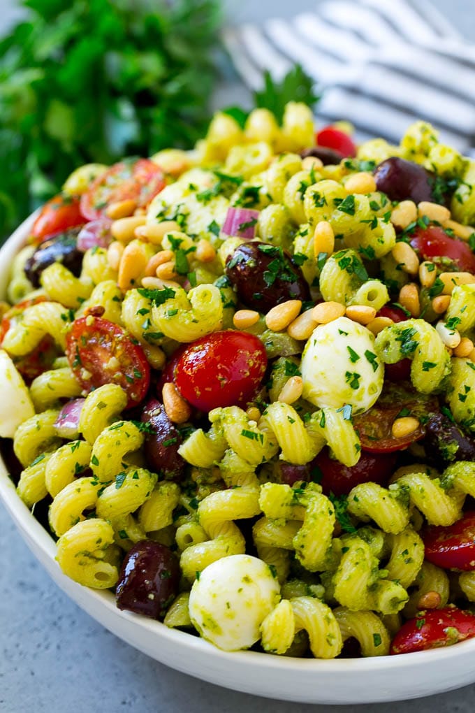 Pesto pasta salad with tomatoes, olive and fresh mozzarella.