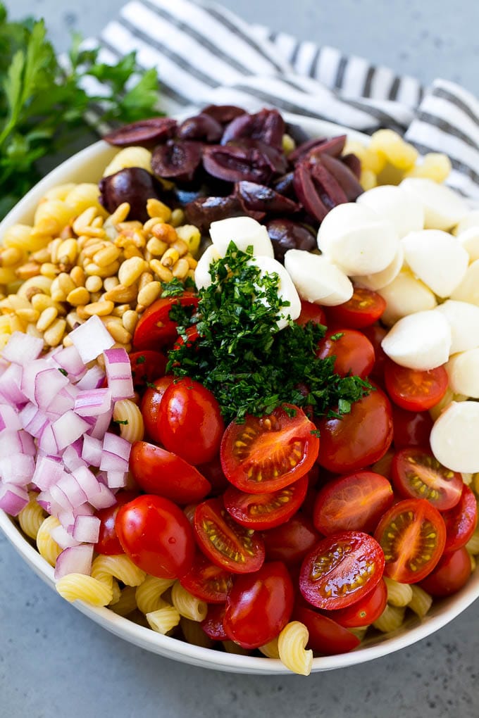 Pasta with cherry tomatoes, mozzarella balls, kalamata olives, parsley and red onion.