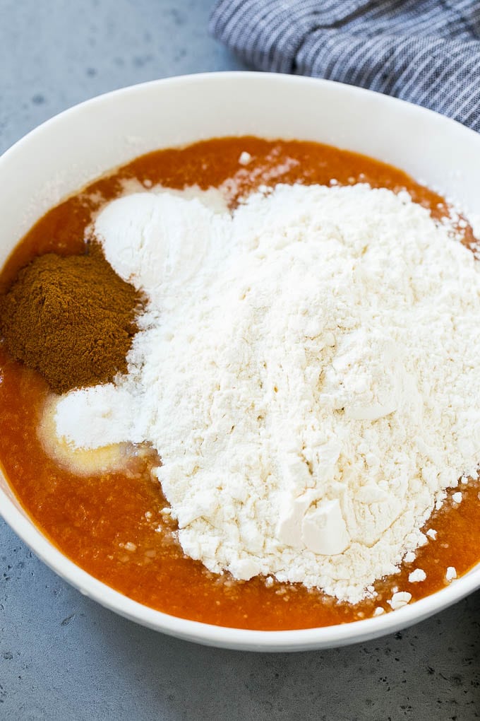 Pumpkin, flour, baking powder and cinnamon in a mixing bowl.