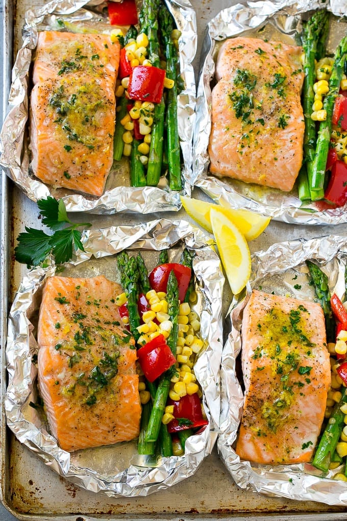 Salmon foil packets in herb butter with vegetables.