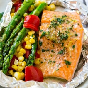 A salmon foil packet that can be baked or grilled with seasoned salmon and fresh vegetables.