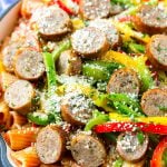 Sausage and pepper pasta with sliced Italian sausage, red and yellow bell peppers and grated parmesan cheese.