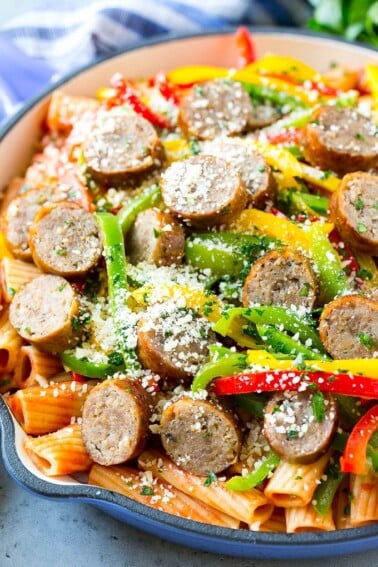 Sausage and pepper pasta with sliced Italian sausage, red and yellow bell peppers and grated parmesan cheese.