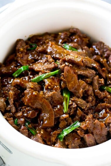 Slow cooker mongolian beef with thinly sliced flank steak cooked with soy sauce, brown sugar, garlic and ginger.