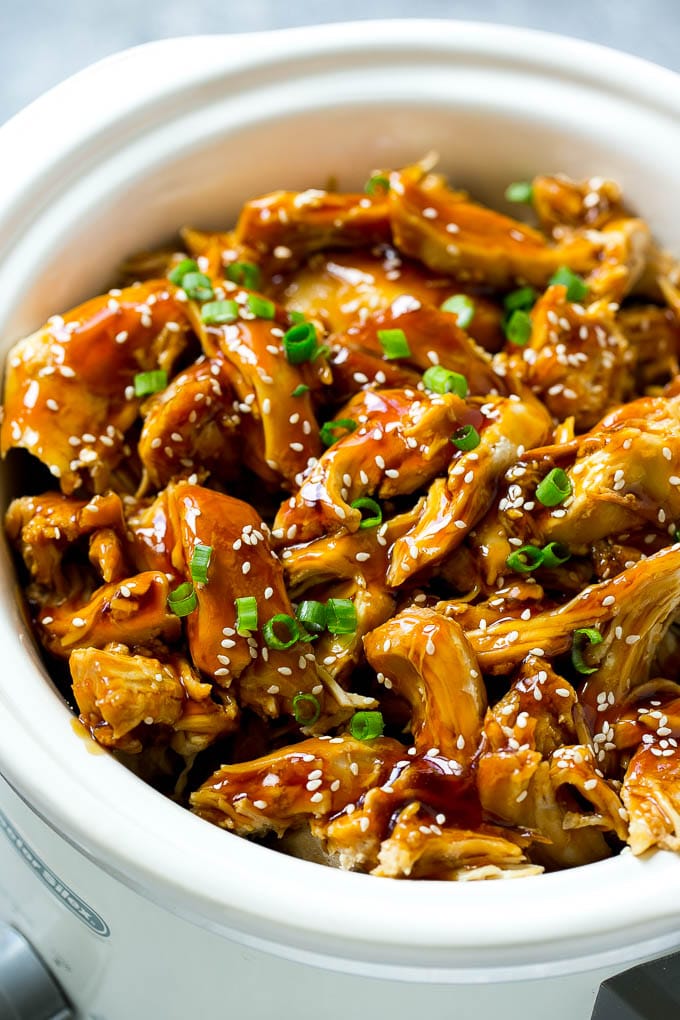 Slow cooker teriyaki chicken with shredded chicken breasts, homemade teriyaki sauce, sesame seeds and green onions.