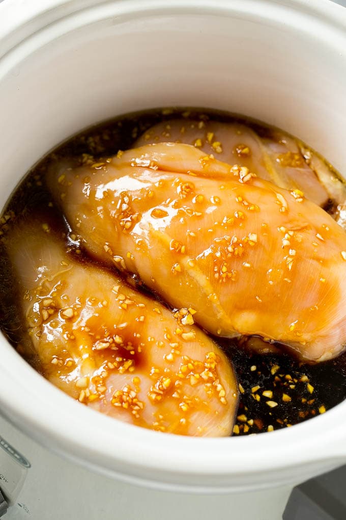 Chicken breasts in a crock pot with soy sauce, garlic and ginger.